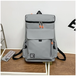 Detail of dark grey travel backpack with Spunk logo and orange zipper accents
