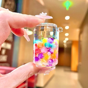 Handheld creative mini bunny jar keychain with colorful floating beads and liquid