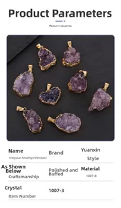Detail view of raw amethyst crystal pendant with gold-plated edges on rock surface