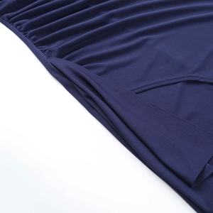 Detail shot of navy blue knitted fabric stitching and drapery texture on dress