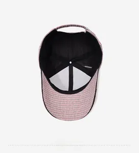 Internal view of houndstooth baseball cap featuring breathable mesh lining and buckle