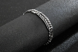 Close-up of gothic wheat pattern carving on vintage silver stainless steel bracelet