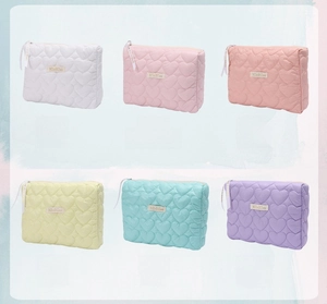 Collage showing quilted heart cosmetic bags in white pink yellow blue and purple tones