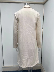 Detail view of the H-line back cut of this beige wool-blend long coat on a mannequin