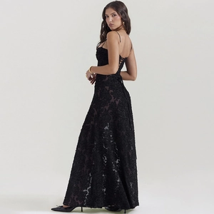 Detailed view of black lace evening dress with cross back straps and open back design