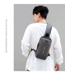 Detail of outdoor sling bag featuring a secure side combination lock on dark grey fabric