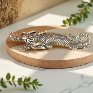 Detailed macro view of vintage brass dragon fish sculpture with intricate scale texture