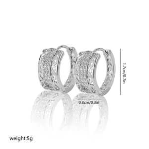 Macro detail of silver hoop earrings showing 1.7cm size, heart pattern and zircon inlay
