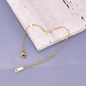 Elegant 18K gold-plated titanium steel bracelet featuring three polished heart pendants