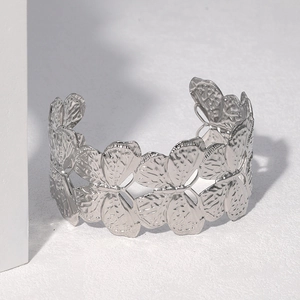 Silver stainless steel butterfly open cuff bracelet with hollow design on white platform