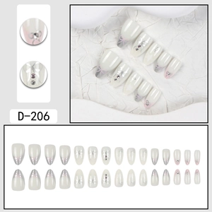 Close-up of D-206 French gradient pink press-on nails with silver bows and rhinestones