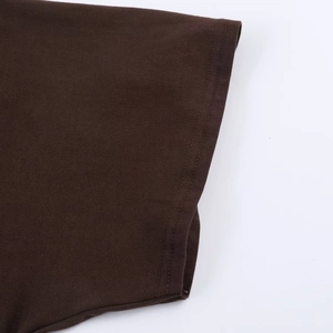 Detail view showing the double-needle stitching on the brown knitted cotton sleeve cuff
