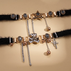 Star and bear plush choker necklace with gold fringe and pearl accents on beige background