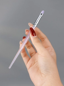 Detail of soft purple fiber bristles on a translucent holographic handle makeup brush