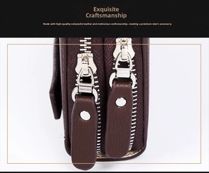 Macro view of dual silver metal zippers and dark brown leather texture on men's clutch
