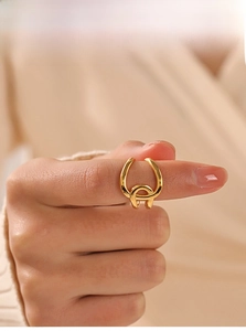 Close-up of golden adjustable 18K gold-plated double-loop ring on a woman's finger