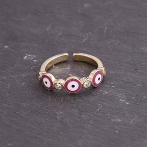 Detailed close-up of gold evil eye open ring with purple enamel and zircon inlay