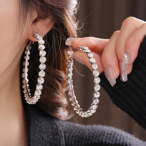 Chic silver hoop earrings with shimmering rhinestones for a bold fashion look