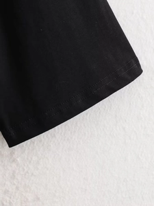 Close-up of high-quality double-needle stitching on black short sleeve lace T-shirt