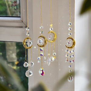 Detailed view of suncatchers with crystal prisms reflecting rainbow light on golden chains