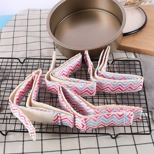 Detail of four colorful wave patterned bake even strips placed on a black cooling rack