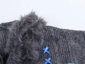 Detail of dark grey knit hoodie with faux fur trim, blue ribbons, and toggle button