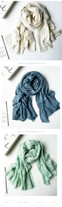Detailed texture of pleated modal scarf with fringe edges in elegant soft colors