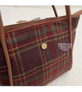Detail of the magnetic snap design on checkered wool tote bag with leather handle