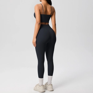Back view of black yoga set showing strappy sports bra and high-waisted leggings