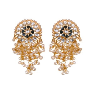 Vintage gold Jhumka earrings with heart droplets, pearls, and black gemstones on white back