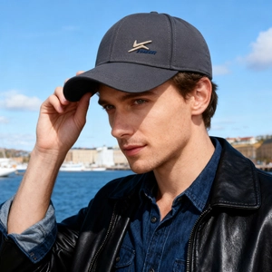 Men's winter warm baseball cap in dark grey with embroidery shown in a stylish outdoor setting