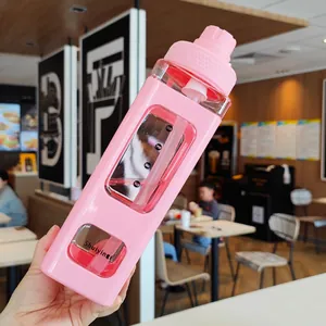 Detail of 900ml pink square plastic sports bottle with straw and capacity markings
