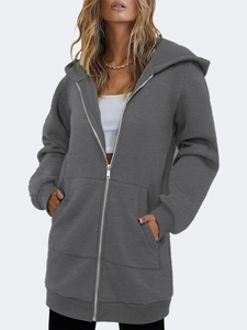Detail of dark grey longline hoodie featuring front zipper and cozy hood texture