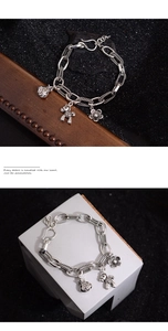 Detailed close-up of retro silver bracelet with flower, horse, and lucky bag charms