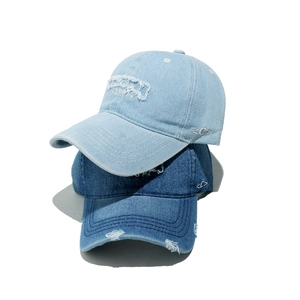 Distressed denim baseball caps with 1987 embroidery and vintage frayed edges