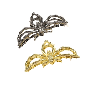 Metallic spider-shaped hair claw clips in gold and gunmetal silver finishes