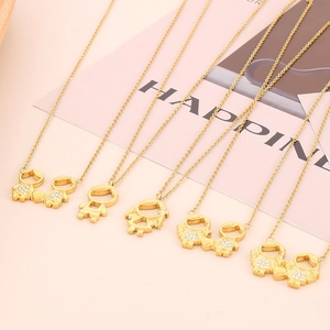 Golden boy and girl cartoon pendants necklace with diamonds on pink background