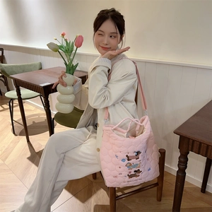 Close-up of pink quilted tote bag featuring cute cartoon dog embroidery and text
