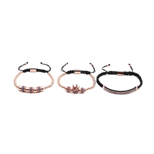 Detail of rose gold braided bracelets set with blue zircon crown and beads charms