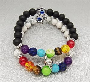 Detail of couple bracelets with magnetic heart clasps, Hamsa Hand and colorful beads