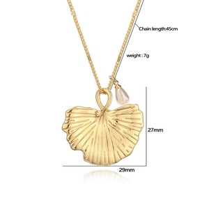 Elegant 18K gold plated ginkgo leaf pendant necklace with pearl charm on white background