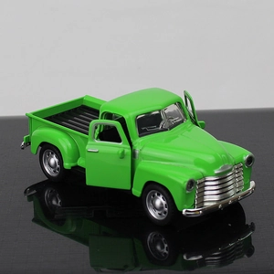 Detail view of vintage green alloy pickup truck model with openable side doors