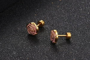 Close-up of gold-plated rose earrings with pink enamel and secure screw backs