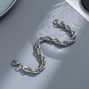 Macro detail of silver braided stainless steel chain link with secure lobster clasp