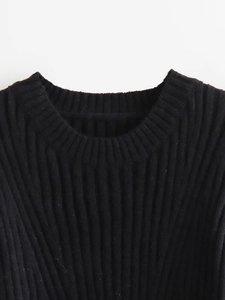 Close-up of the black ribbed knit crew neck detail on a slim-fit sweater dress