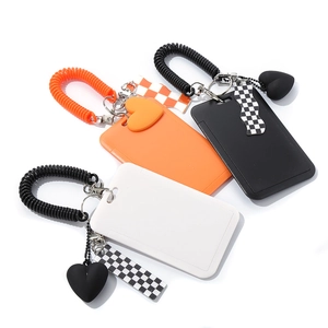 Checkered heart keychain card holders in orange, black, and white with spiral wristbands