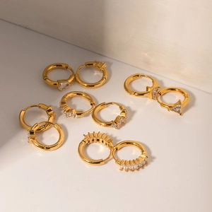 Close-up of 18k gold plated stainless steel hoop earrings with pear-cut zircon stones