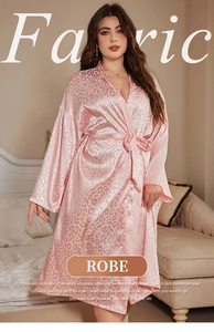Detail of pink leopard print satin robe showing shiny silk fabric and belted waist design