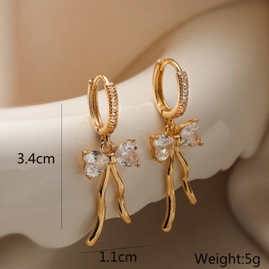 Detail view of gold-plated bow earrings with clear zircons, size 3.4cm and weight 5g