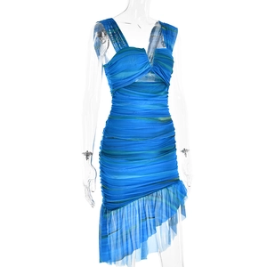 Detail view of the blue ruched V-neck dress featuring an asymmetric ruffled hemline